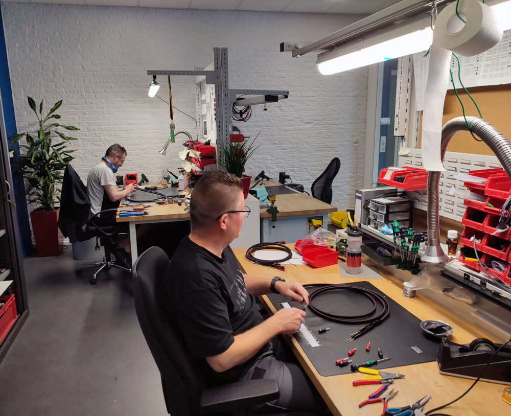 AudioQuest production facility in Roosendaal showing cable assembly workstations